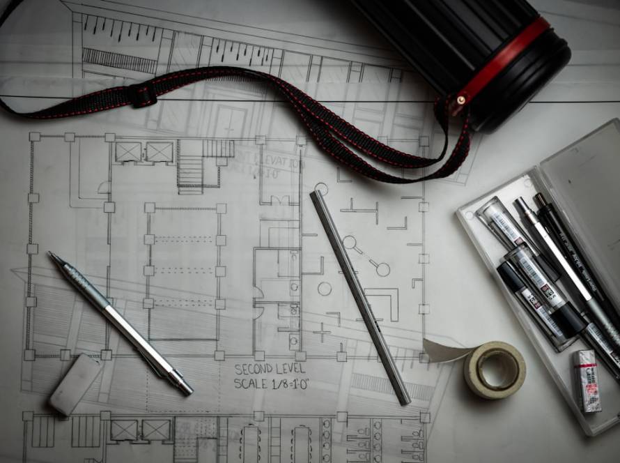 Architectural blueprint sketch with drafting pencils